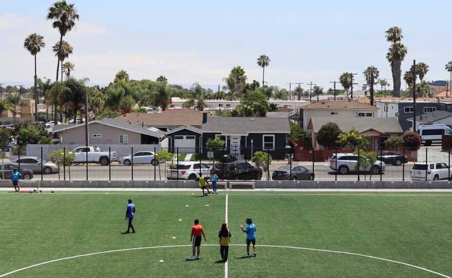 Students and soccer coaches walk on Wilson Middle School's turf soccer field on Monday, July 21, 2025.