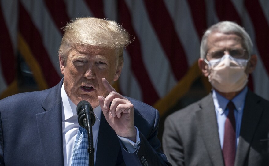 A masked Dr. Anthony Fauci joins President Trump as he delivers remarks about the coronavirus vaccine development Friday in the Rose Garden.