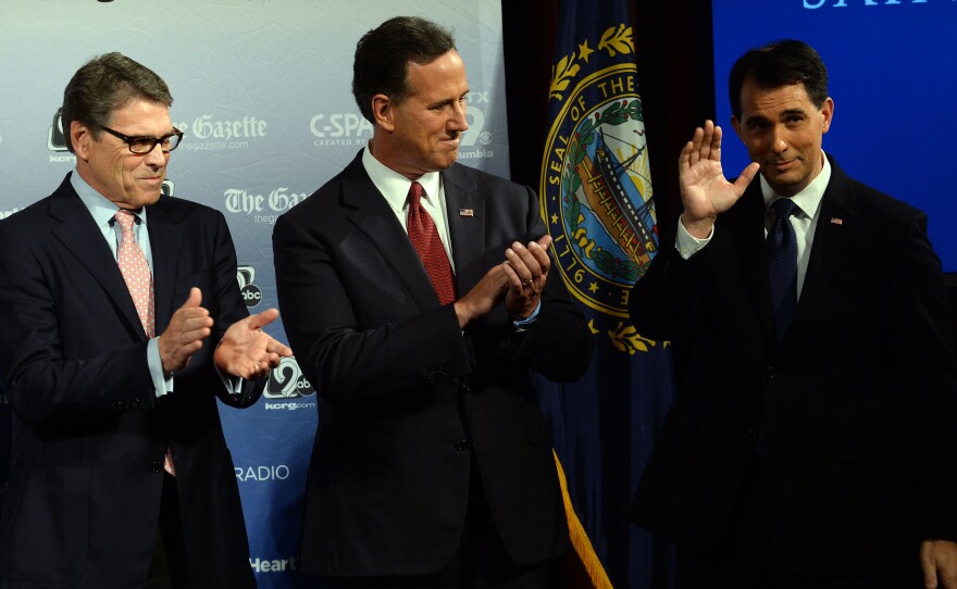 Former Texas Gov. Rick Perry, left, former Sen. Rick Santorum, center, and Wisconsin Gov. Scott Walker on stage before a candidate forum in New Hampshire earlier this week.
