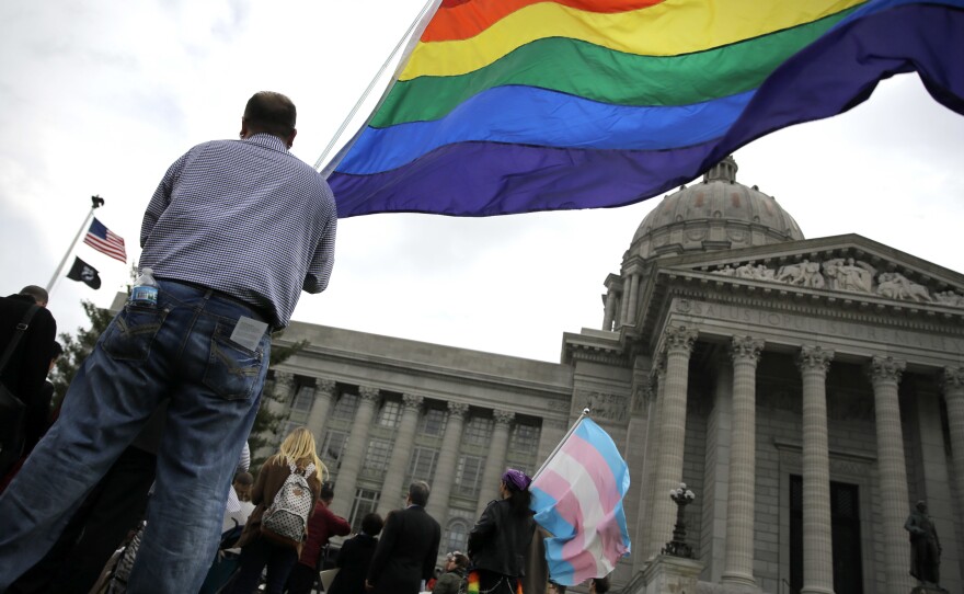 Mathew "Skippy" Mauldin holds a flag during a rally outside the Missouri State Capitol, on March 31, in Jefferson City. He was protesting a proposed state constitutional amendment to protect some businesses citing religious objections while denying goods or services related to same-sex weddings.
