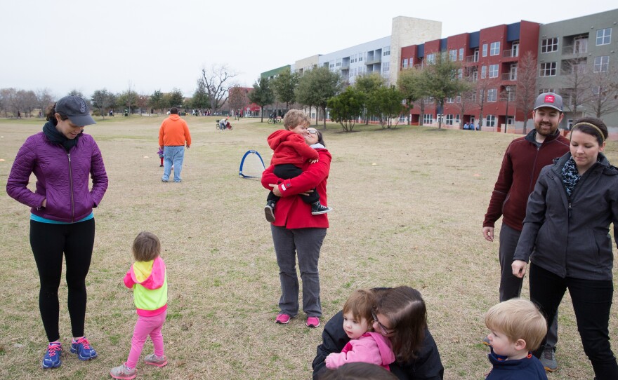 Holly Adams (center) hugs her son Felix, after soccer practice at Mueller's 30-acre Lake Park on Jan. 31. Many residents mention having a high level of social engagement with their neighbors.