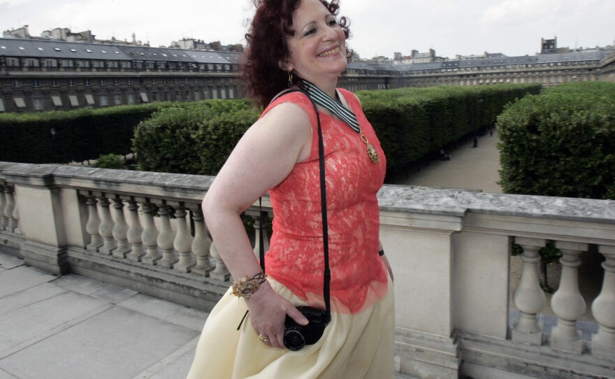 Photographer Nan Goldin poses after being awarded Commander in the Arts and Letters Order, in Paris, June 27, 2006.