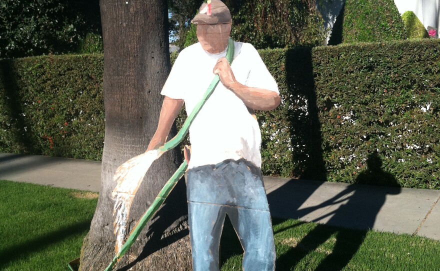 Gomez makes life-size cardboard cutouts of laborers — such as this "gardener" on North Beverly Drive — and leaves them on manicured lawns.