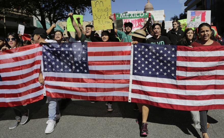 Demonstrators march through downtown Austin, Texas, on Thursday. Protesters are targeting recent immigration raids around the country.