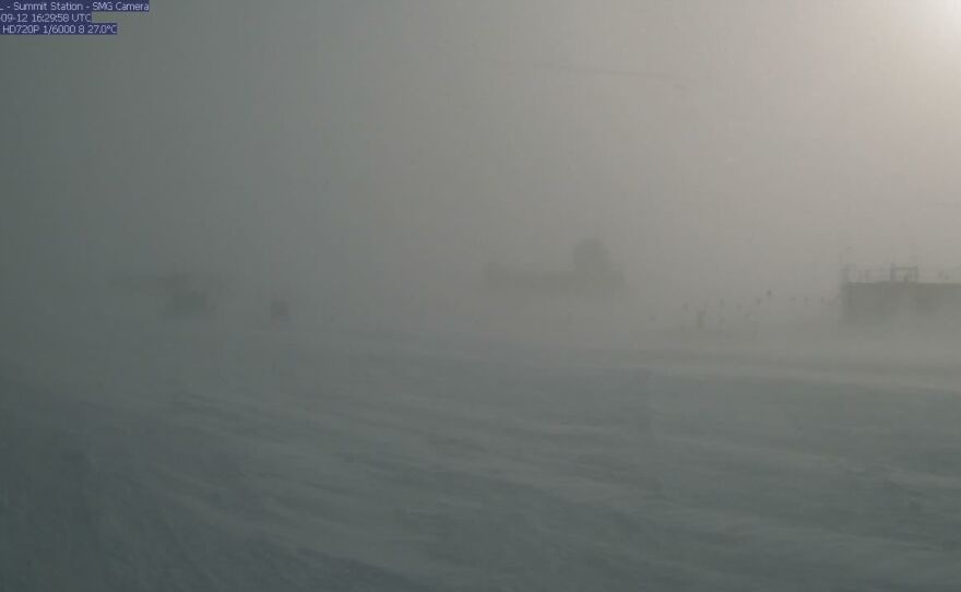 A webcam still showing blizzard conditions at Summit Station, a weather research station at Greenland's highest point. In August, the station recorded rain for the first time ever.