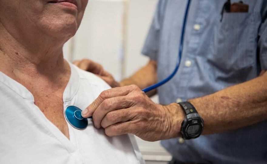 A doctor listens to a patient's heartbeat at the Mountain Valley Health Center in Bieber on July 24, 2019.