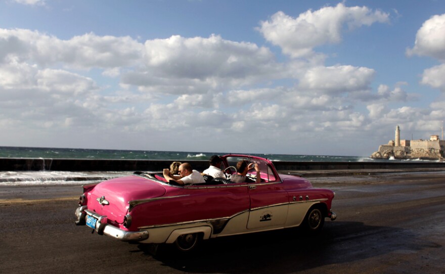 Tourists ride along Havana's Malecon in April 2009. A push is under way in Congress to do away with bans on U.S. travel to Cuba.