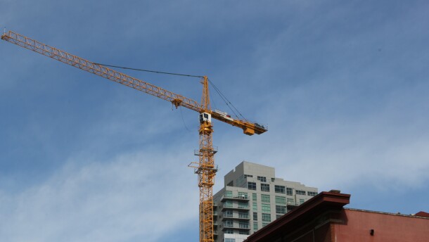 A construction crane towers over downtown San Diego. 