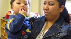 Susan Pham holds her son, Nathan. Pham meets with other mothers twice a month to discuss parenting, motherhood and life. The meetings are part of a support program for at-risk families.