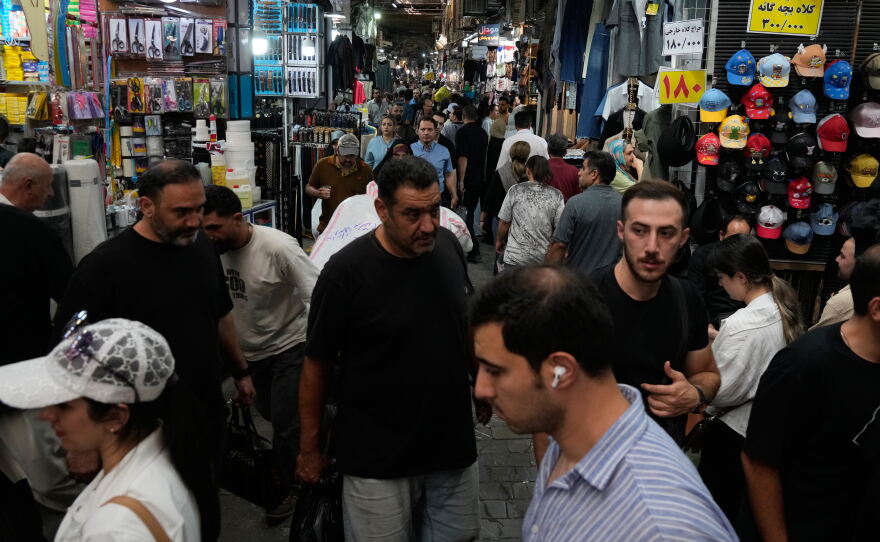 People walk in Tehran's traditional main bazaar, Iran, Saturday, Aug. 8, 2026.
