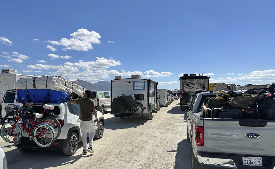 Vehicles line up in a several-hour wait to leave the Burning Man festival in Black Rock Desert, Nev., Tuesday, Sept. 5, 2023. The traffic jam leaving the festival eased up considerably Tuesday as the exodus from the mud-caked Nevada desert entered a second day following massive rain that left tens of thousands of partygoers stranded there for days.