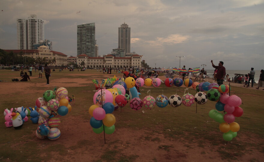 Vendors hawk their wares at the Galle Face Green, a popular seaside park in the Sri Lankan capital Colombo, for the Buddhist and Tamil New Year's celebrations. Vendors say there's not many customers these days — folks just don't have money to spend, partly because of the latest Mideast war.