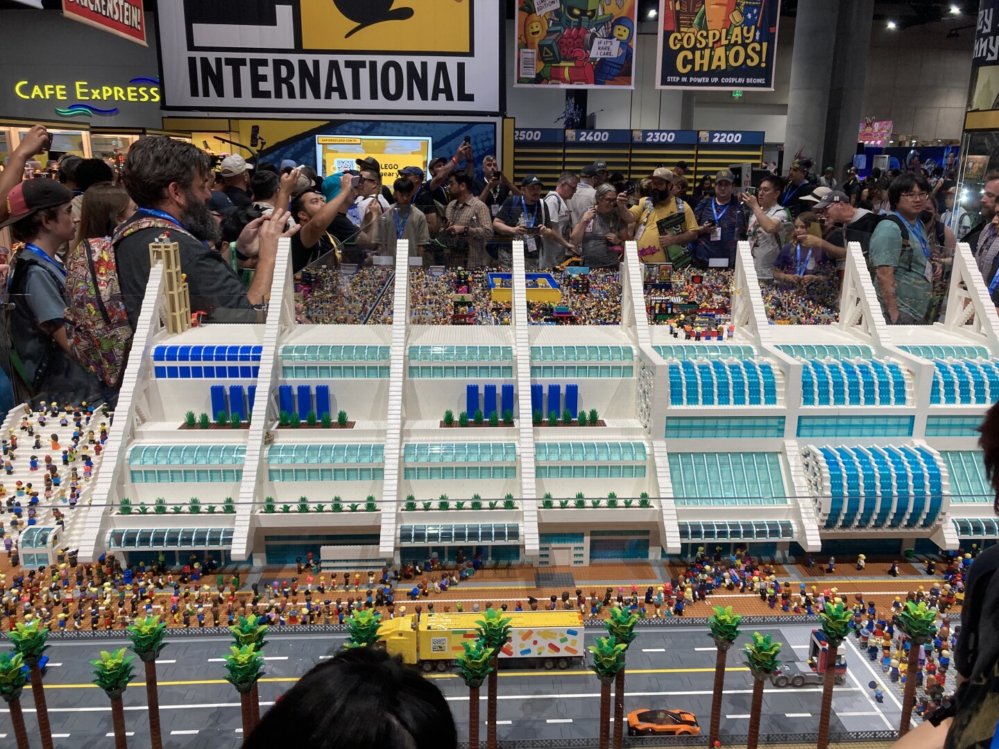 The San Diego Comic-Con International Convention diorama spans multiple tables. Attendees gather around the construction and take photos of the LEGO masterpiece on July 23, 2025.