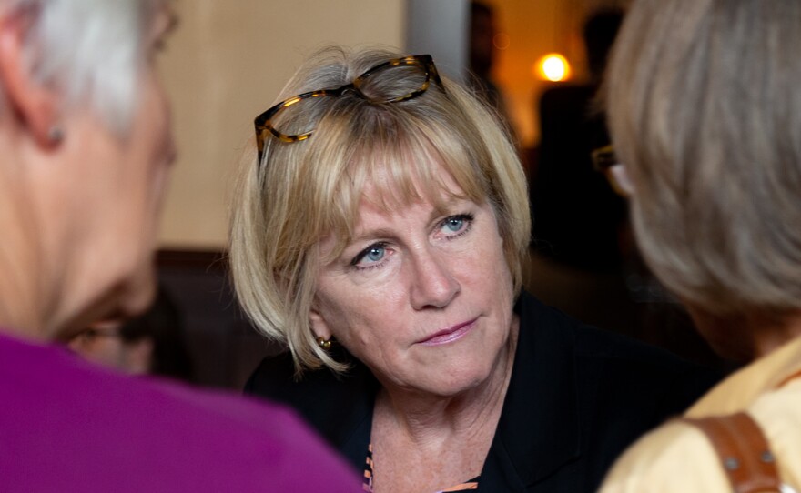 Democratic gubernatorial candidate Cathy Glasson campaigns one week before the primary election in a Des Moines restaurant. She says she thinks in order to win against Republican Gov. Kim Reynolds, she and her fellow candidates need to run far to the left.