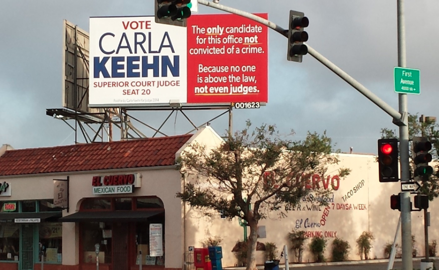 Federal prosecutor Carla Keehn, hoping to unseat Judge Lisa Schall in the June primary election, put four billboards around San Diego accusing her opponent of being a criminal, May 8, 2014.