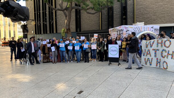 Members of community groups opposed to use of Flock cameras in San Diego, gather at Civic Center Plaza for a news conference on December 4, 2025.