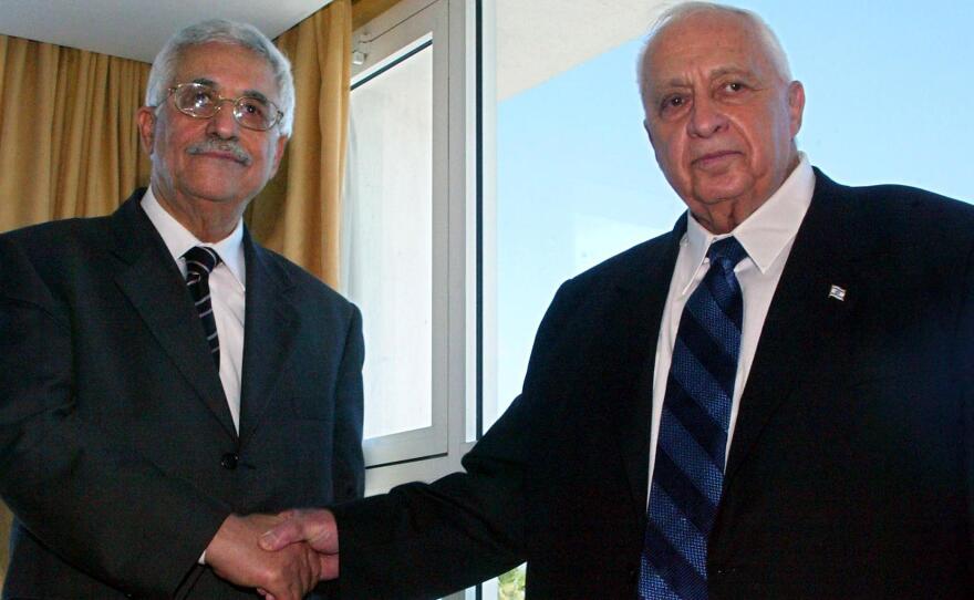 Palestinian leader Mahmoud Abbas (left) and Israeli Prime Minister Ariel Sharon shake hands before their summit meeting in Sharm El-Sheikh, Egypt, on Feb. 8, 2005. Abbas and Sharon declared a ceasefire to end four years of deadly violence. Since then, there have been long periods of low-level violence, punctuated by brief, intense bouts of killing.