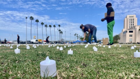 People set up flameless tea lights in San Diego's Watefront Park to honor homeless San Diegans who have died. Oct. 10, 2025.