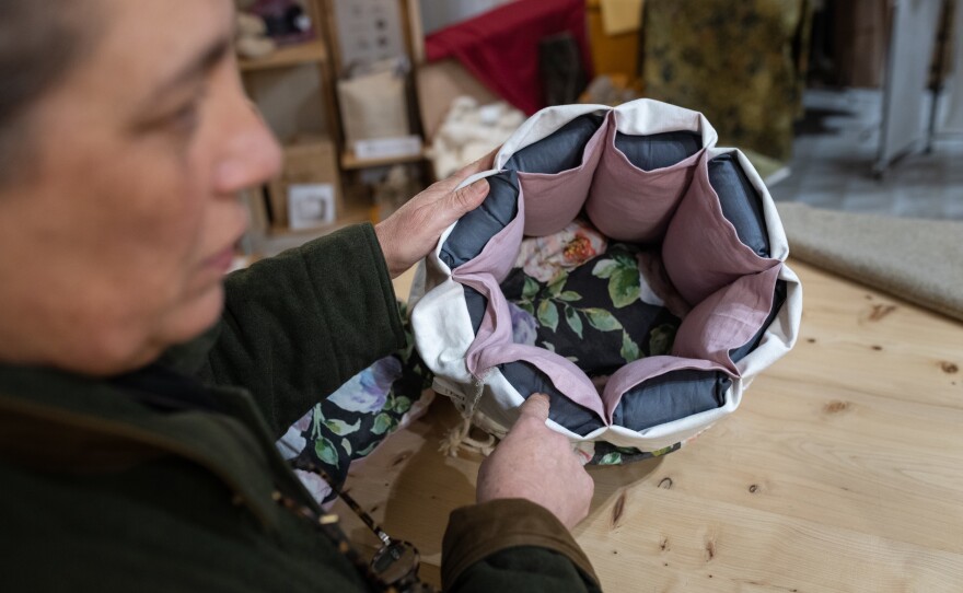 Gloria Lucchesi shows a cooking container in the shop of the association Filo & Fibra in San Casciano dei Bagni on Nov. 12.