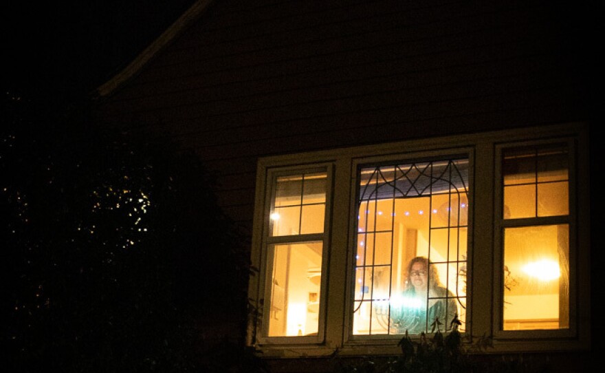 Beth Richman's menorah pierces the darkness outside of her Portland, Ore., home.