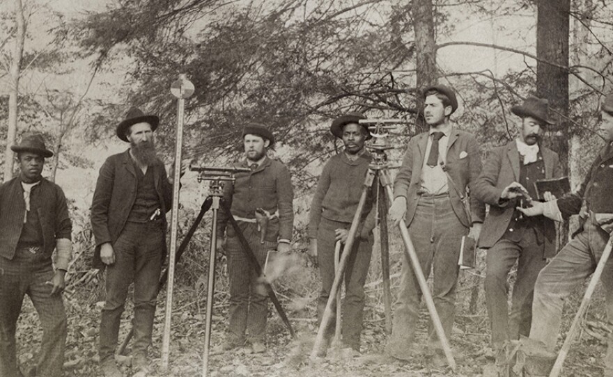 William Anderson Hatfield, second from left, holds a surveying pole as unidentified workers and civil engineers pose with their equipment during the construction of the Ohio extension of the Norfolk & Western Railroad. Circa 1893.
