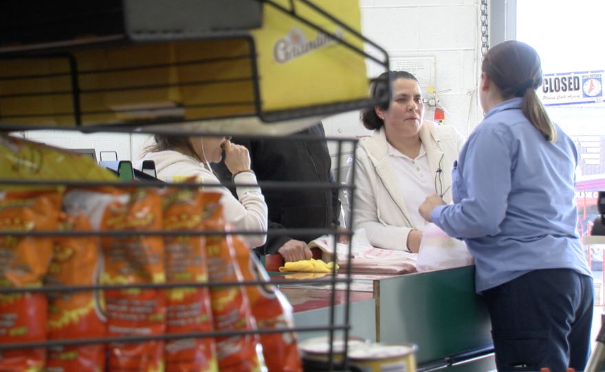 Teresa Gomez works at the cash register at a Barrio Logan grocery store, Jan. 20, 2017. 