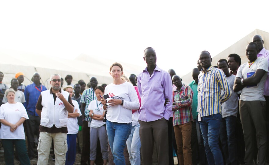 Stefania Poggi (center, in white jersey) oversees the morning meeting at the MSF hospital.