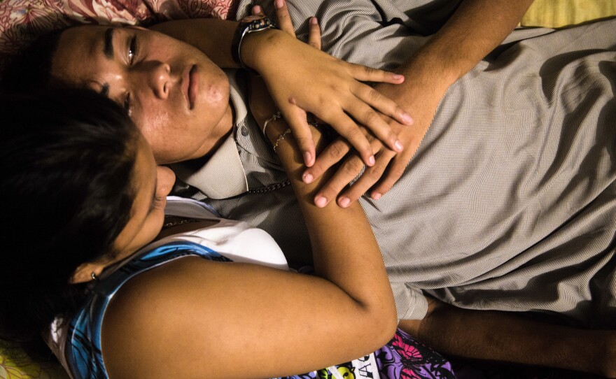 Moises and his girlfriend, Cindi, discuss their future. When Ayuso took this photo, she had just told Moises that she is pregnant. They discussed their options; Moises said he would consider migrating to save himself from gang violence — and be able to make money for the child.