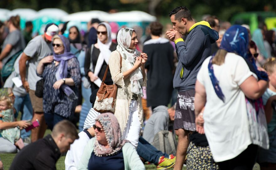 Women wore headscarves as they gathered for the Muslim call to prayer in Hagley Park in Christchurch on Friday. The call was broadcast across New Zealand in memory of 50 people who were killed in attacks at two mosques last Friday.
