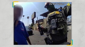 An immigration agent arrests a worker at the Hand J car wash in Los Angeles during a raid in August 2025.