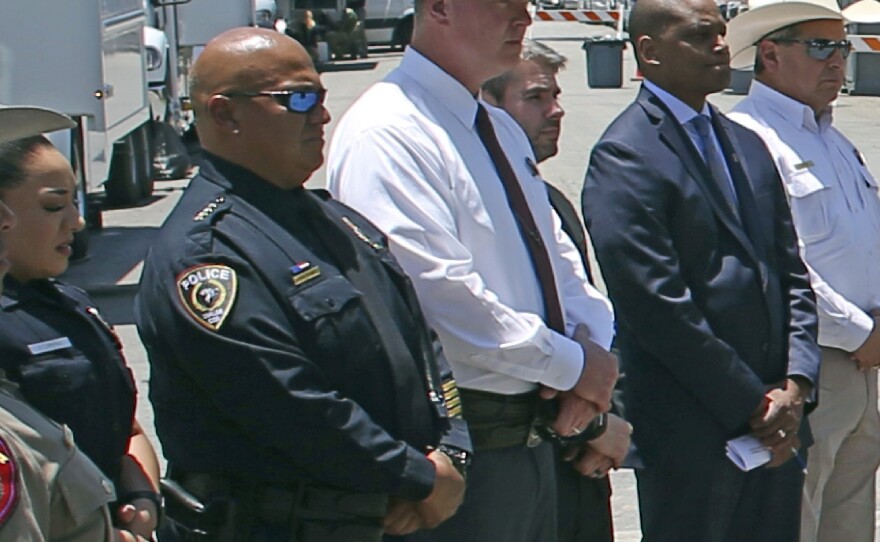 Uvalde School Police Chief Pete Arredondo (second from left) stands during a news conference outside of the Robb Elementary School in Uvalde, Texas, on May 26. He resigned as a member of the Uvalde City Council and remains on administrative leave for his police role.