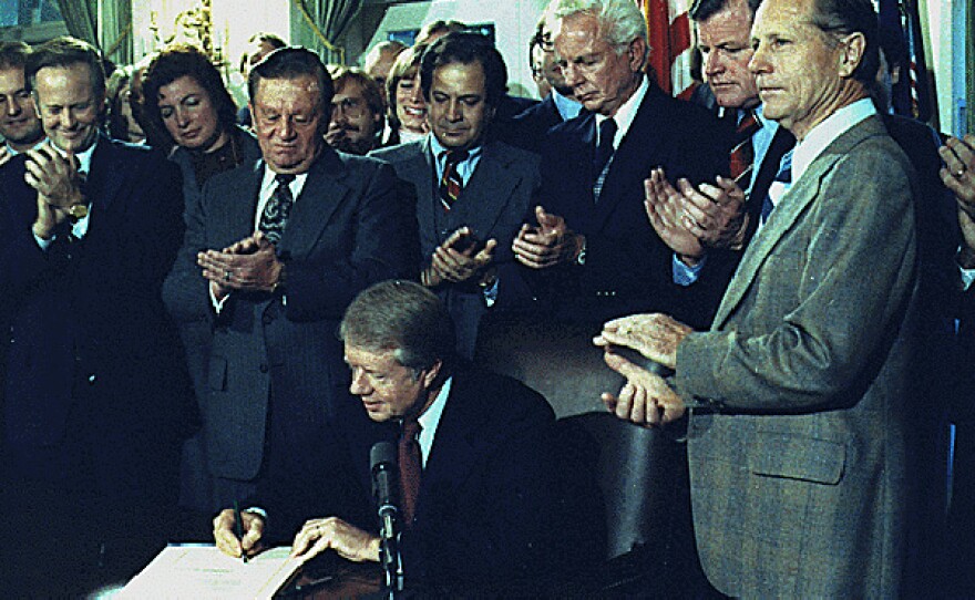 President Jimmy Carter signs the Airline Deregulation Act of 1978.