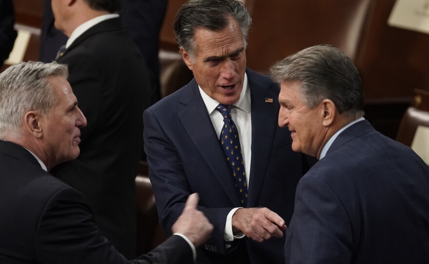 Sen. Mitt Romney, R-Utah, speaks with Sen. Joe Manchin, D-W.Va., and U.S. House Minority Leader Kevin McCarthy, R-Calif., before President Biden delivers the State of the Union address on March 1. Romney negotiated with Senate Majority Leader Chuck Schumer on a deal for another round of COVID aid.