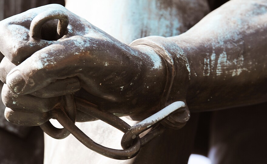 The chained hand of Archer Alexander, who was the last slave captured under the fugitive slave law, is depicted in a statue commemorating the Emancipation Proclamation. A bill to study reparations for slavery advanced through a House committee this year but hasn't gotten a floor vote.