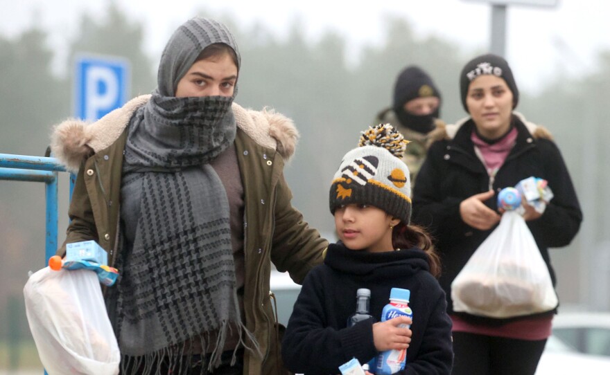Migrants receive humanitarian aid in a tent camp near the Bruzgi checkpoint, on Wednesday.