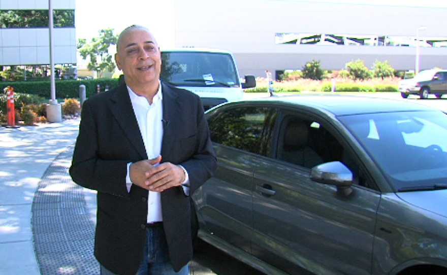 Kanwalinder Singh, standing in front of Audi's first 4G car, pitches Qualcomm's vision for a more connected car, Sept. 26, 2014. 