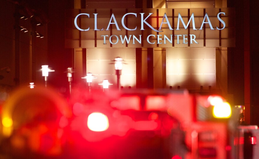 The lights of emergency vehicles illuminated the night Tuesday at the Clackamas Town Center mall just outside Portland.