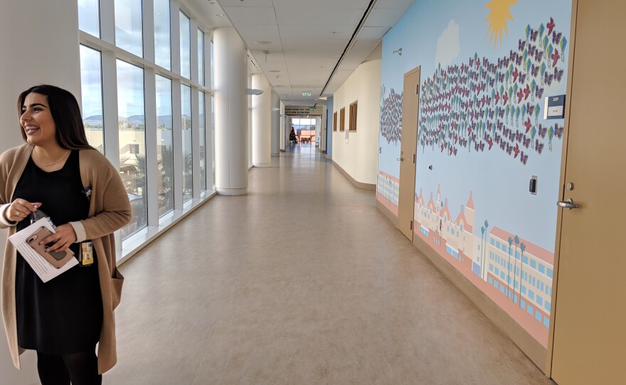 Wendy Mejia, a program coordinator for Rady Children's Hospital's Center for Healthier Communities, stands in a hallway at the medical facility's main campus in Kearny Mesa, Dec. 17, 2018.
