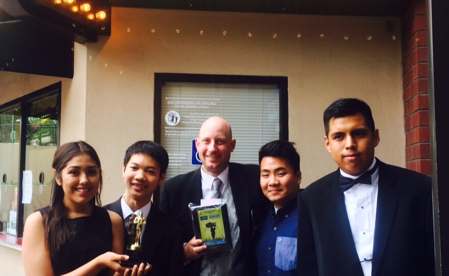 Hoover High School Teacher John Michener (center) and students pose with an award from the 2015 Innovative Video in Education competition.