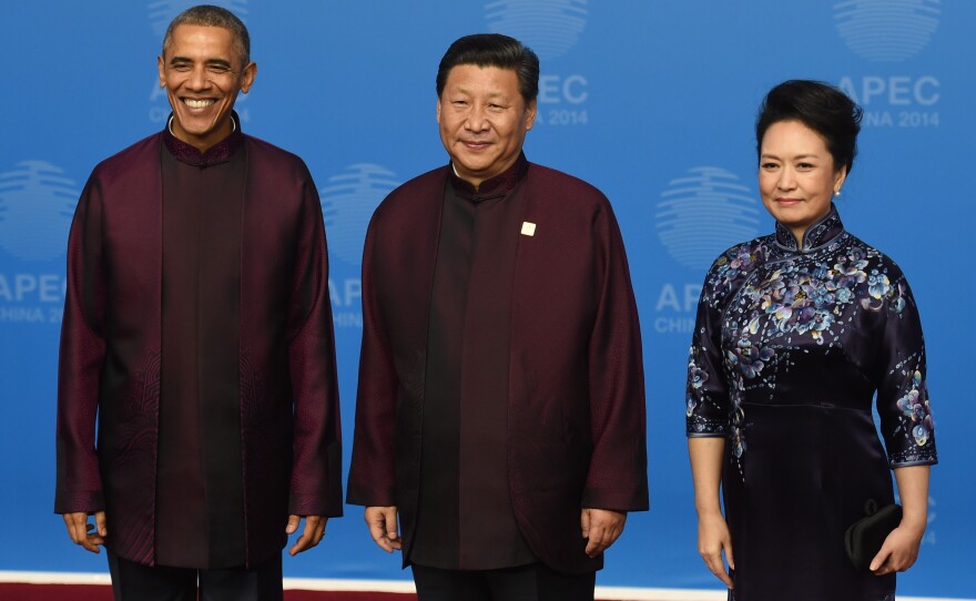 President Barack Obama poses with Chinese President Xi Jinping and his wife, Peng Liyuan, as they arrive for the APEC banquet Monday. It's traditional for leaders attending the summit to dress alike for a photo-op.