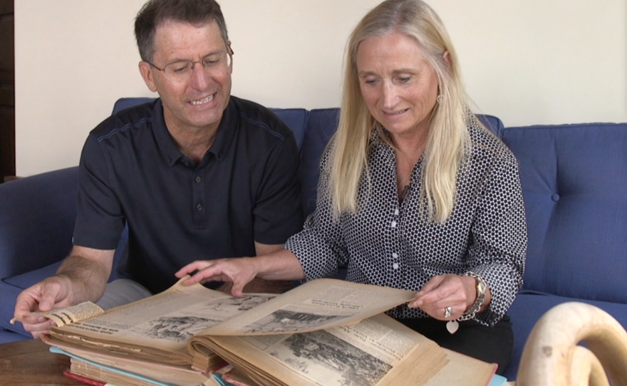 Former Ecke YMCA board members Bob Ayers and Lizbeth Ecke look at childhood photographs, April 23, 2015.