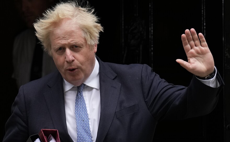 British Prime Minister Boris Johnson leaves 10 Downing Street in London on Wednesday. A report into lockdown-breaching U.K. government parties says blame for a culture of rule-breaking in Johnson's office must rest with those at the top.