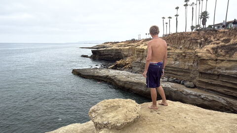 Enzo Bledsoe stands ready to cliff jump at Pappy's Point at Sunset Cliffs, Aug. 5, 2026.