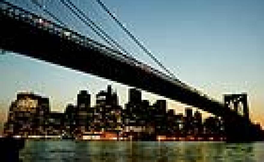 The lights of lower Manhattan blaze under the Brooklyn Bridge as electricity returned to New York City Aug. 15, following the largest power outage in U.S. history.