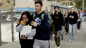 Students are escorted out of Saugus High School after a shooting on Thursday, Nov. 14, 2019, in Santa Clarita, Calif., that left two dead and wound three others. 