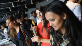 Job applicants meet potential employers at the NYC Startup Job Fair held in September. Last month, the private sector created jobs while the public sector resumed laying off workers.