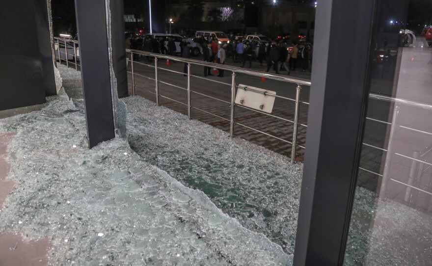 Shattered glass is pictured on the floor following a rocket attack in Arbil, the capital of the northern Iraqi Kurdish autonomous region, on February 15, 2021.