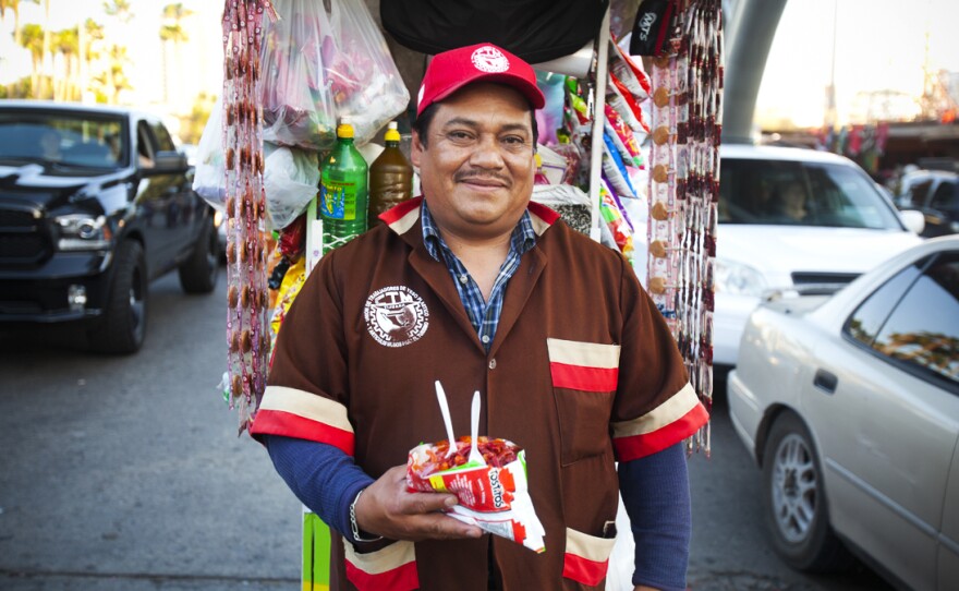 Tijuana street vendor Fidencio Rodriguez displays a freshly-made batch of Tostilocos, a unique border snack making inroads in the U.S.
