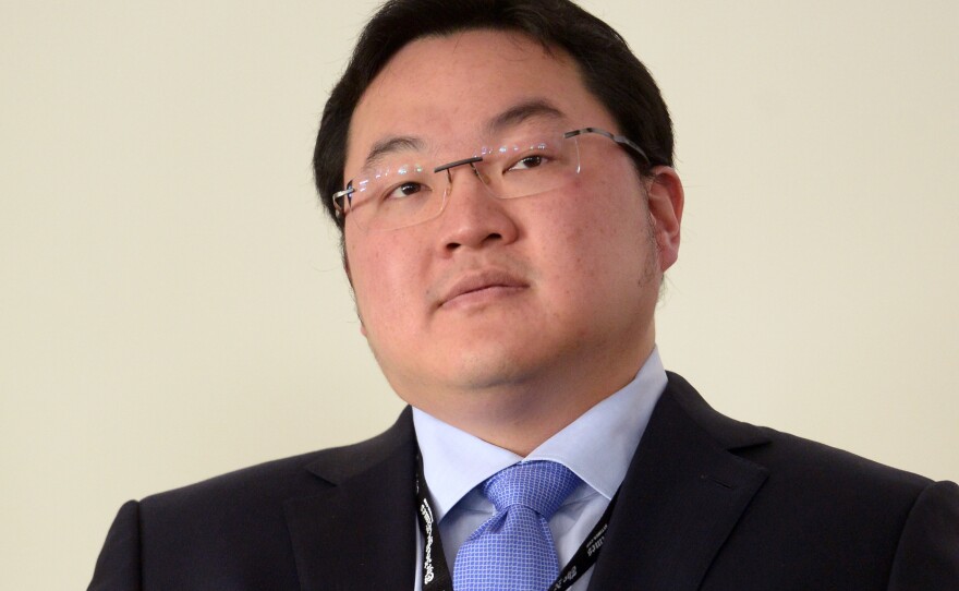 Accused of misappropriating billions of dollars, Jho Low has reached a settlement over U.S. claims related to more than $700 million in assets. But he also says he will continue to fight the charges. The Malaysian financier is seen here in 2014.