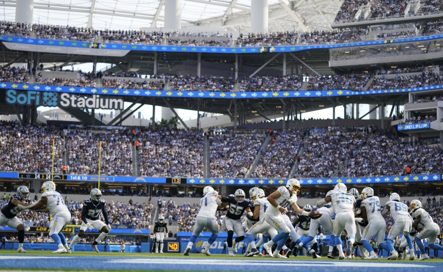 Los Angeles Chargers quarterback Justin Herbert hands off to running back Austin Ekeler (30) during the second half of an NFL football game Sunday, Sept. 19, 2021, in Inglewood, Calif.